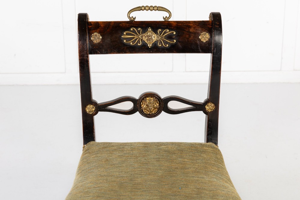 A set of six early nineteenth-century Regency dining chairs crafted from dark wood with brass inlay detailing, brass top handles, and green upholstered seats. View VII