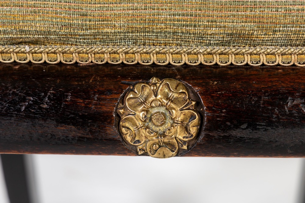 A set of six early nineteenth-century Regency dining chairs crafted from dark wood with brass inlay detailing, brass top handles, and green upholstered seats. View IX