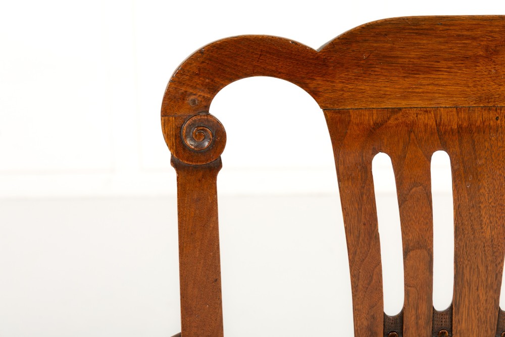 A pair of 18th-century George III mahogany armchairs featuring carved crest rails, vertical slatted splats, curved armrests, and needlepoint upholstered seats. View VII