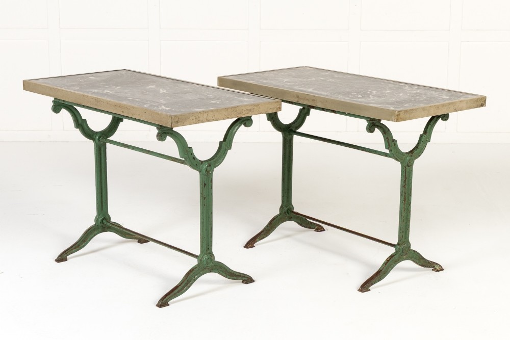 A pair of 19th-century bistro tables featuring rectangular grey veined marble tops framed in brass above weathered green-painted cast iron bases. View II
