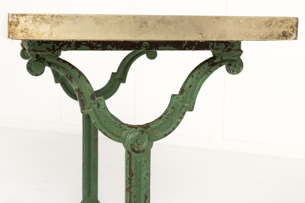 A pair of 19th-century bistro tables featuring rectangular grey veined marble tops framed in brass above weathered green-painted cast iron bases. View VI