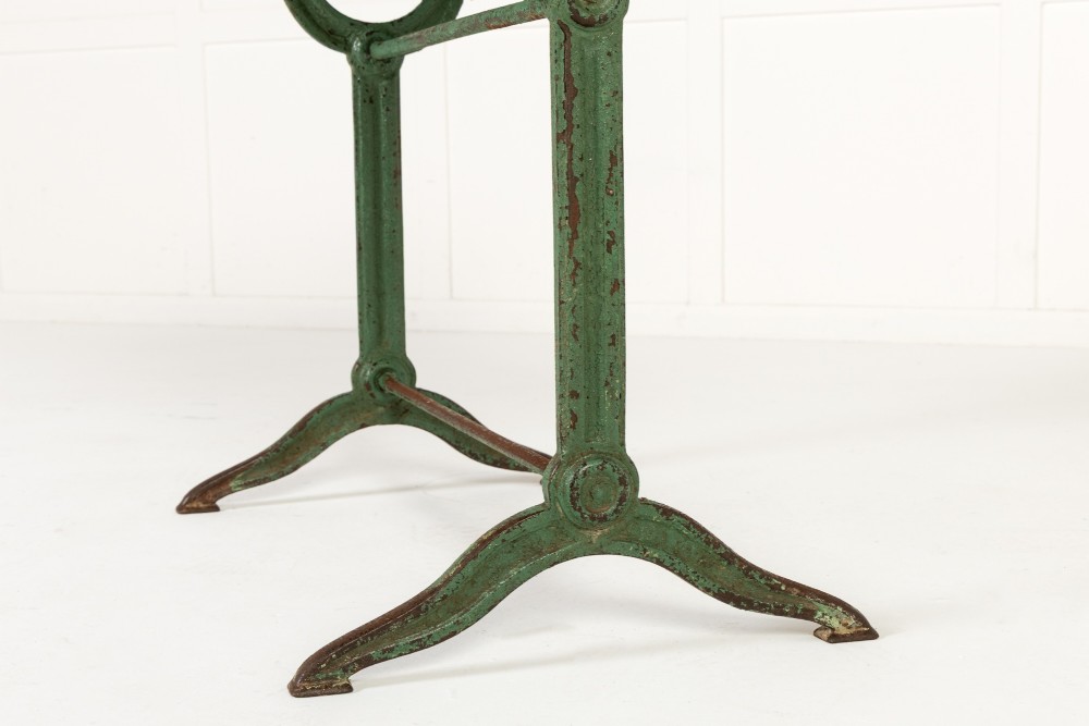 A pair of 19th-century bistro tables featuring rectangular grey veined marble tops framed in brass above weathered green-painted cast iron bases. View VII