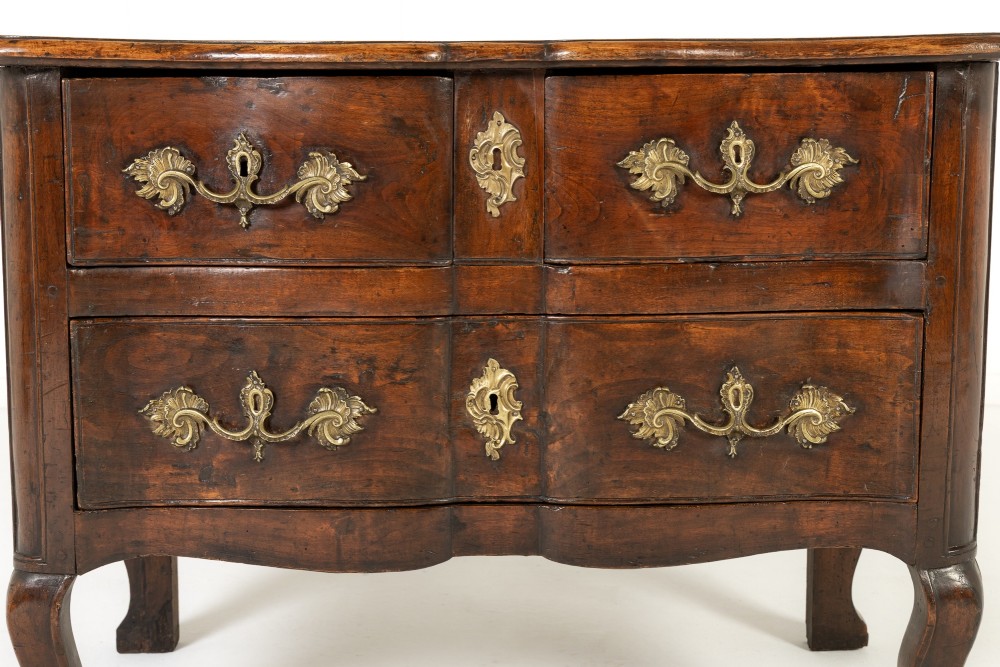 An 18th-century French walnut commode featuring two drawers with cast brass handles, a serpentine front, and cabriole legs. View II