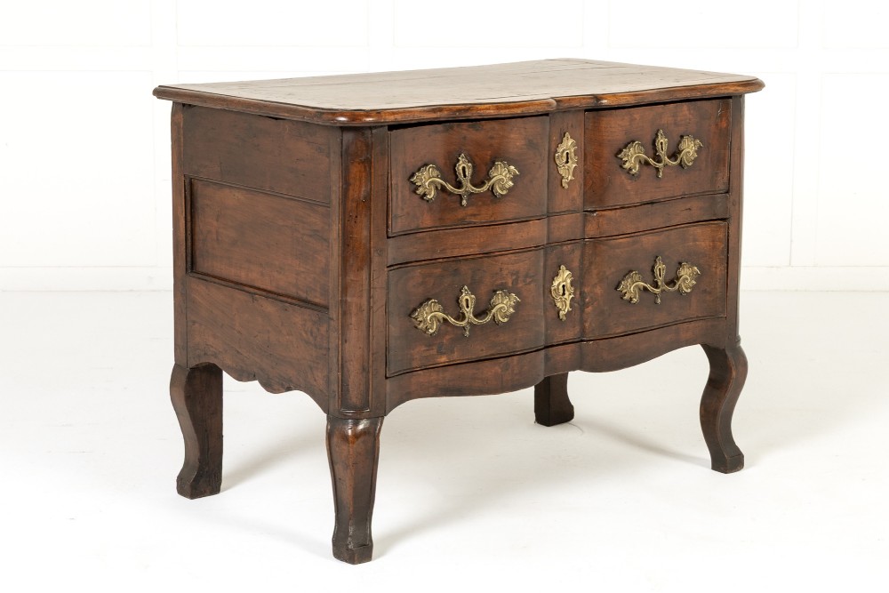 An 18th-century French walnut commode featuring two drawers with cast brass handles, a serpentine front, and cabriole legs. View VIII