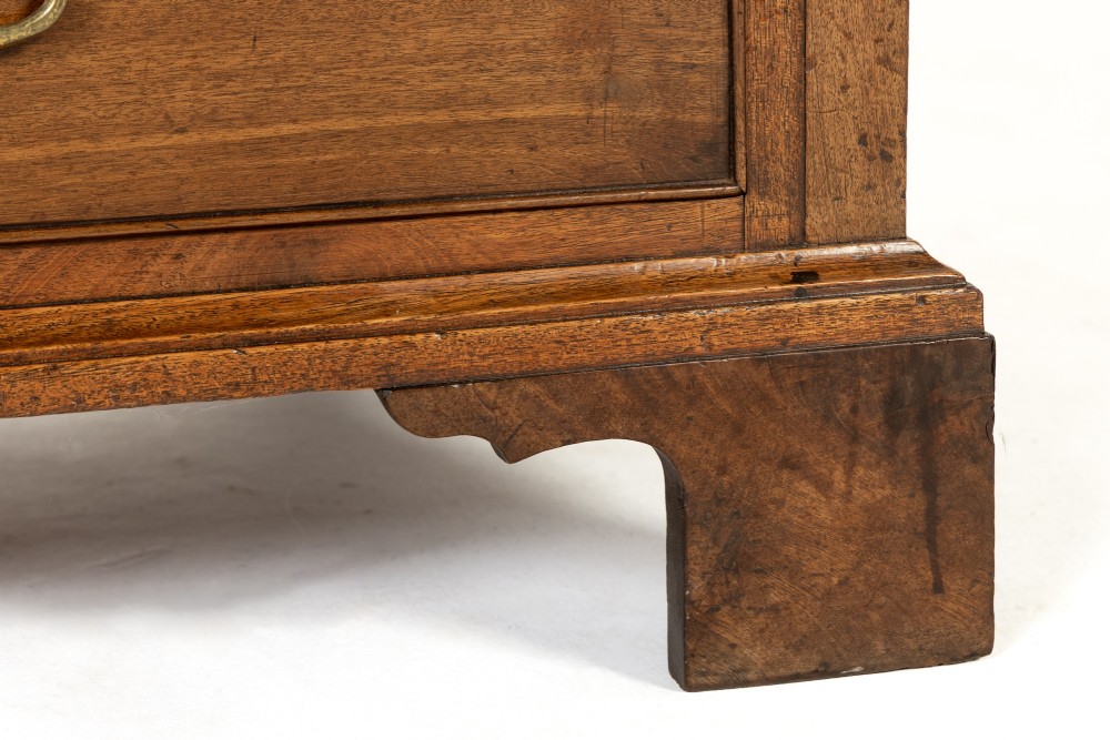 An 18th-century George III mahogany chest of drawers featuring two short over three long graduated drawers with brass swan-neck handles and bracket feet. View V