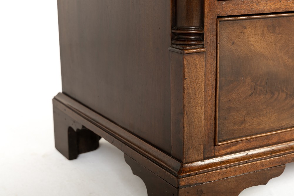 An 18th-century George III mahogany chest of drawers featuring two short over three long graduated drawers with brass swan-neck handles and bracket feet. View VI