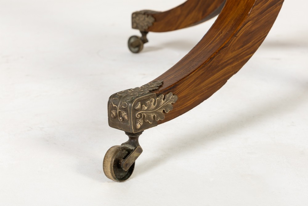 A nineteenth-century Regency circular centre table made of rosewood with a quadripod pedestal base on brass castors. View III
