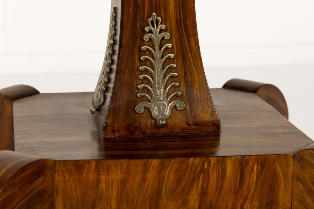 A nineteenth-century Regency circular centre table made of rosewood with a quadripod pedestal base on brass castors. View IV