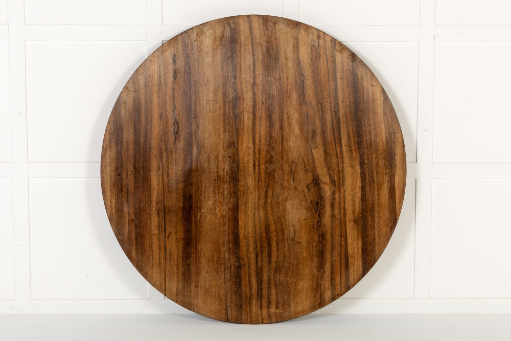 A nineteenth-century Regency circular centre table made of rosewood with a quadripod pedestal base on brass castors. View VI