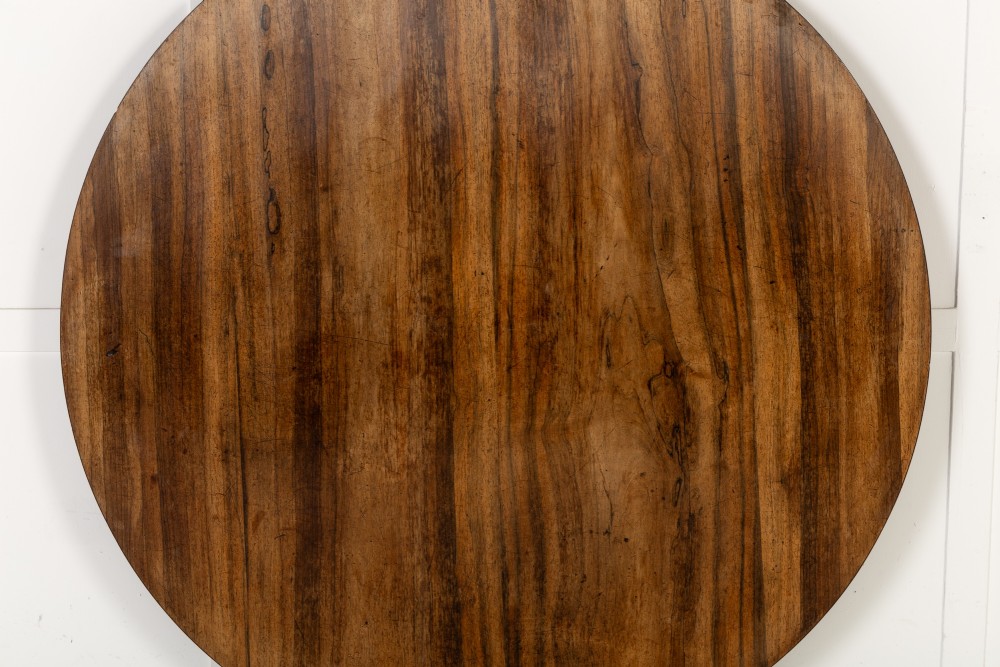 A nineteenth-century Regency circular centre table made of rosewood with a quadripod pedestal base on brass castors. View VII