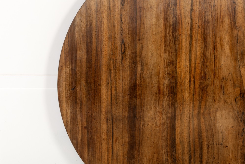 A nineteenth-century Regency circular centre table made of rosewood with a quadripod pedestal base on brass castors. View VIII
