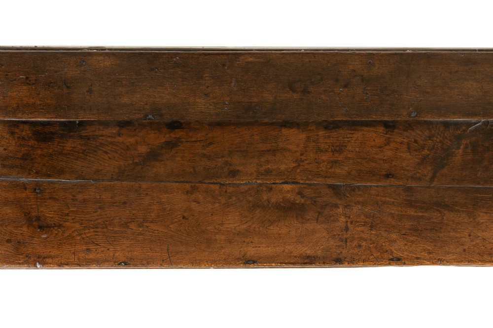 An 18th-century dark oak dresser base featuring geometric panelled drawer fronts, a shaped lower apron, turned front legs, and a bottom potboard shelf. View IX