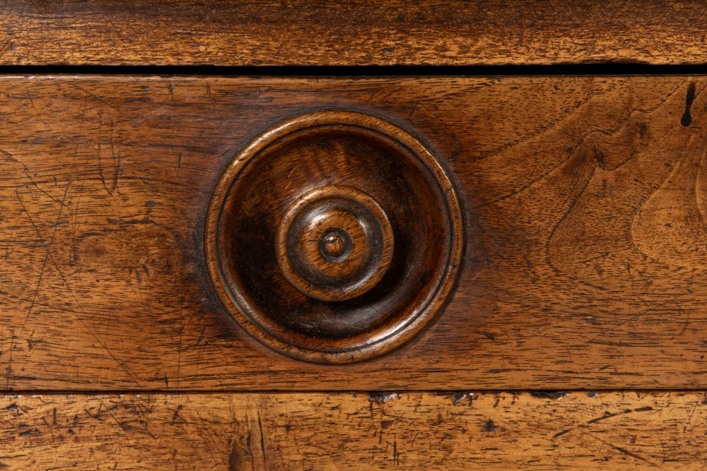 A 19th-century French walnut drapers table with three drawers, wooden knobs, a central keyhole, and turned legs with lower stretchers. View III