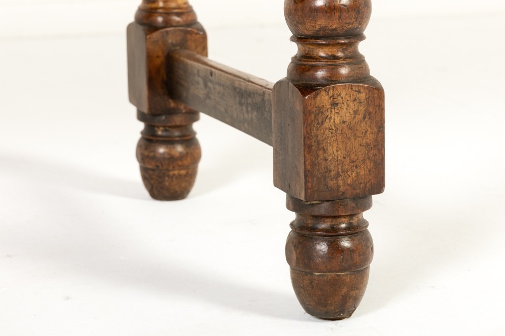 A 19th-century French walnut drapers table with three drawers, wooden knobs, a central keyhole, and turned legs with lower stretchers. View VII