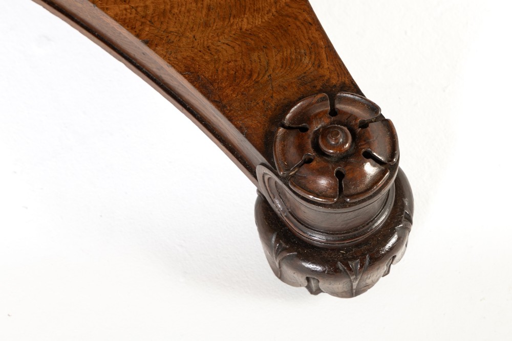 An early nineteenth-century circular centre table featuring a figured burr oak top mounted on a carved central column and a tri-form base with carved feet. View III