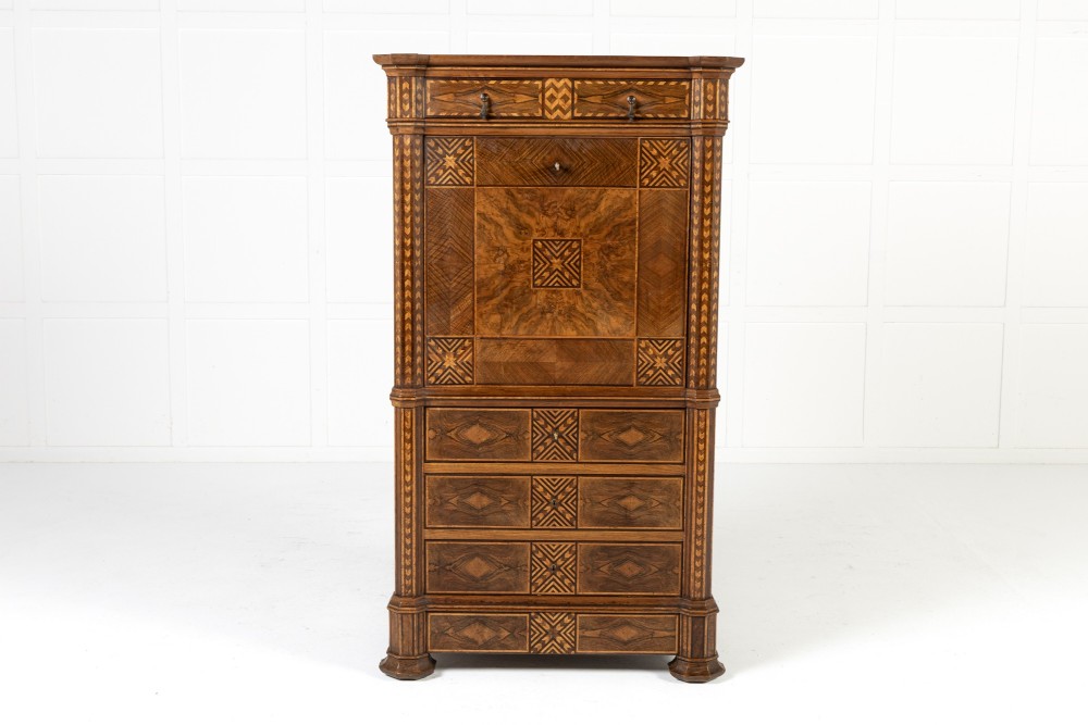 A tall nineteenth-century Italian secretaire cabinet featuring geometric marquetry veneer, a drop-front fall, and stacked drawers.