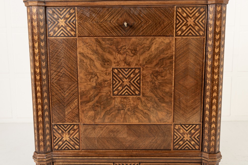 A tall nineteenth-century Italian secretaire cabinet featuring geometric marquetry veneer, a drop-front fall, and stacked drawers. View VI