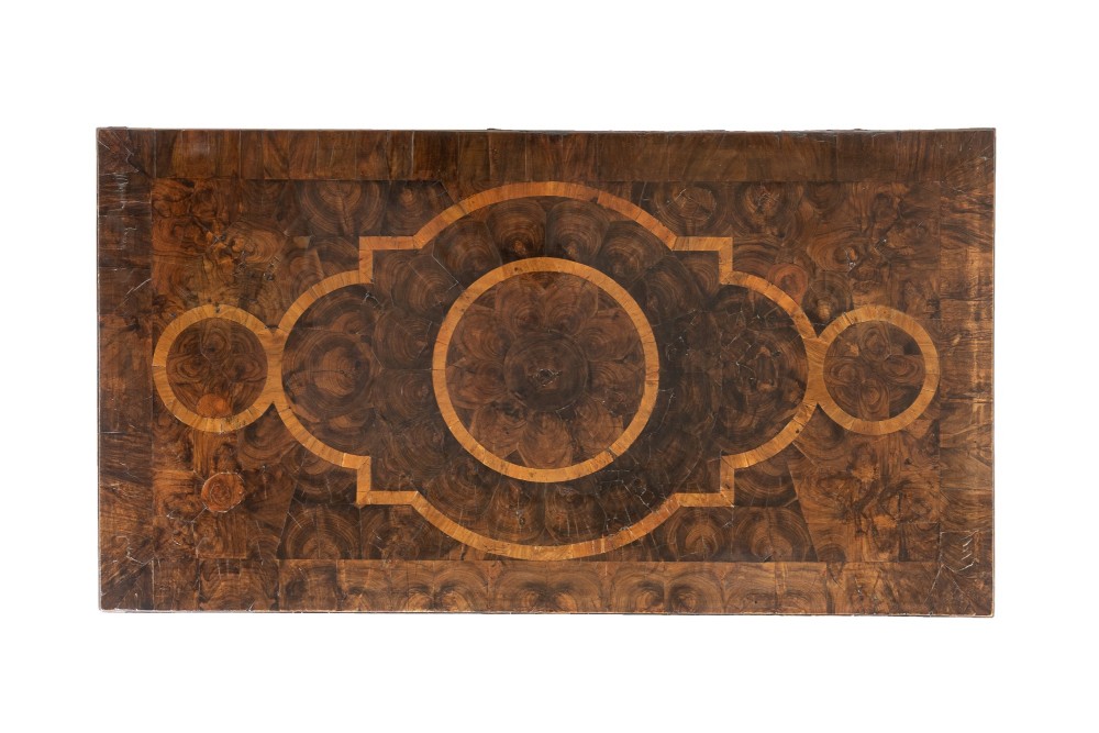 A late 17th-century Dutch walnut chest of drawers featuring geometric oyster veneering, brass drop handles, keyhole escutcheons, and large turned bun feet. View IV