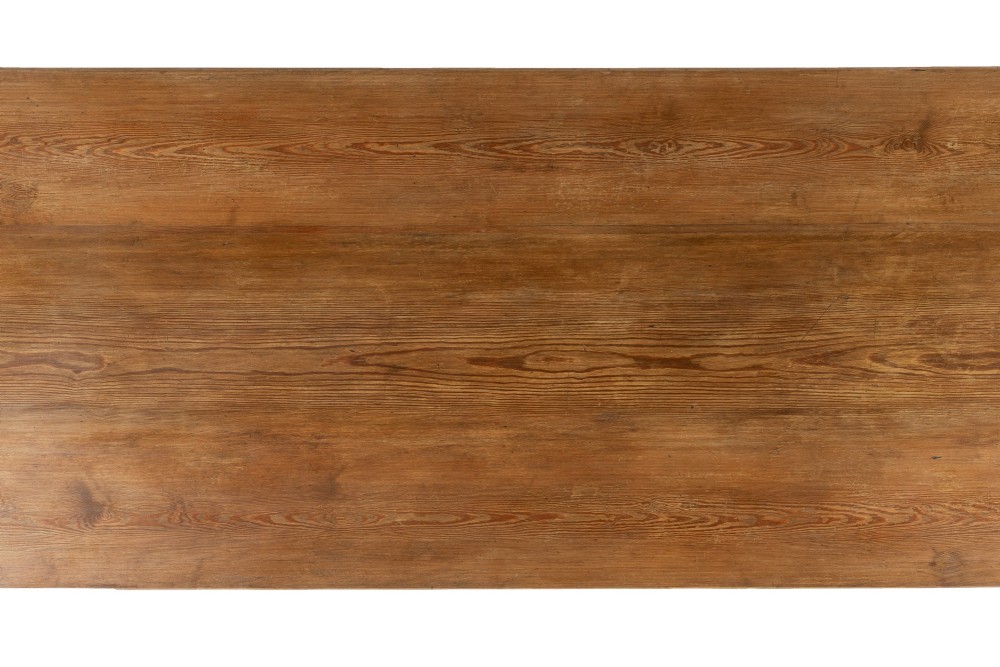 An English pine refectory dining table featuring a rectangular plank top resting on an X-frame trestle base with a central stretcher. View IV