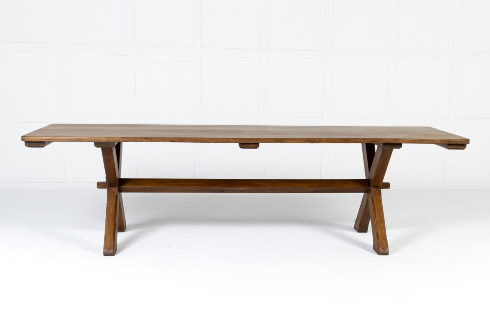 An English pine refectory dining table featuring a rectangular plank top resting on an X-frame trestle base with a central stretcher. View VIII