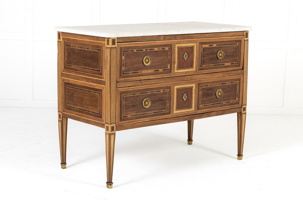 A pair of 18th-century Italian Neoclassical chests of drawers featuring geometric wood inlays, brass ring handles, light marble tops, and tapered square legs. View III