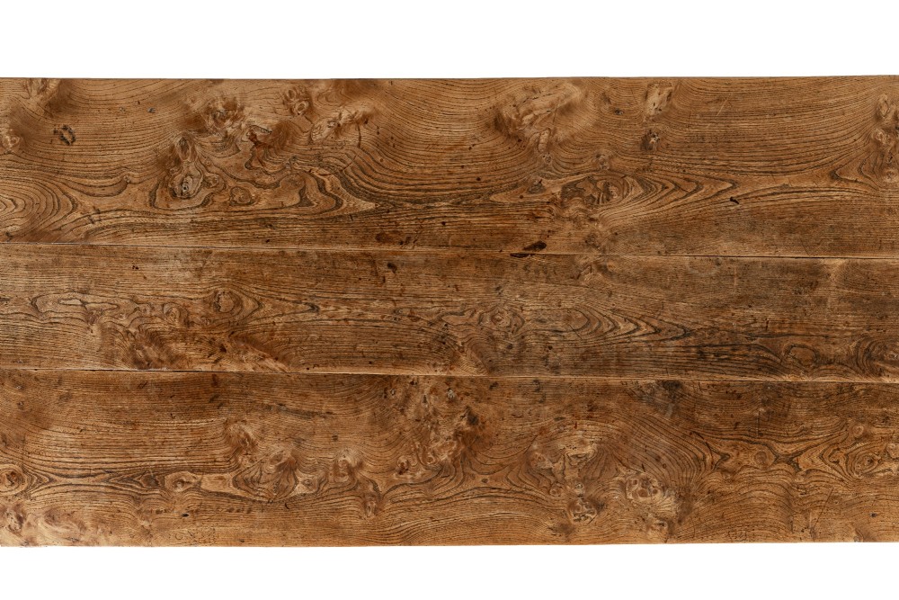 An 18th-century English elm farmhouse table featuring a rectangular plank top with prominent wood grain, a side drawer with brass knobs, and tapered square legs. View III