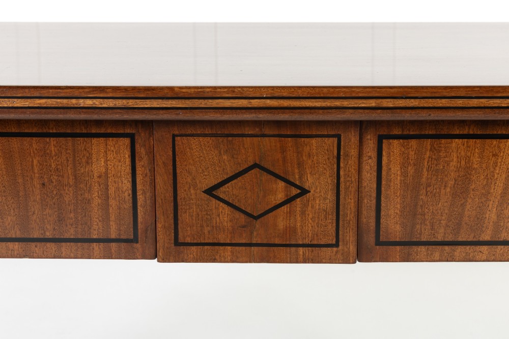 A close-up detail of a 19th-century mahogany serving table frieze featuring dark ebony stringing inlay with a central diamond motif.