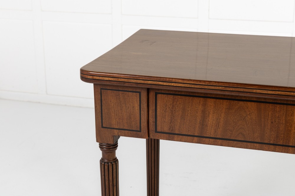 A close-up detail of a 19th-century mahogany serving table frieze featuring dark ebony stringing inlay with a central diamond motif. View II