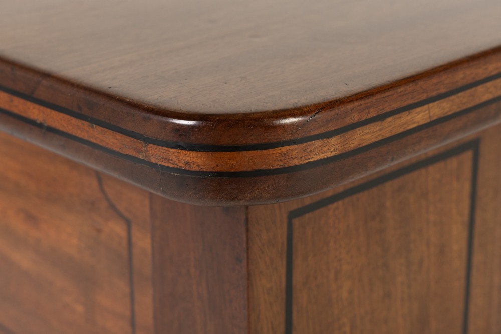 A close-up detail of a 19th-century mahogany serving table frieze featuring dark ebony stringing inlay with a central diamond motif. View V