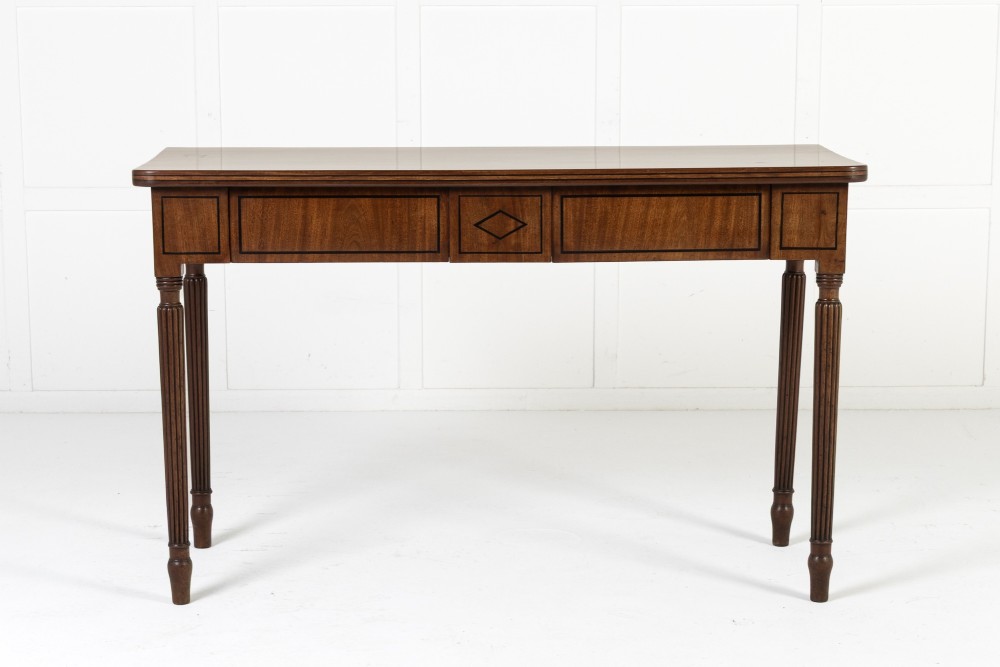 A close-up detail of a 19th-century mahogany serving table frieze featuring dark ebony stringing inlay with a central diamond motif. View VII