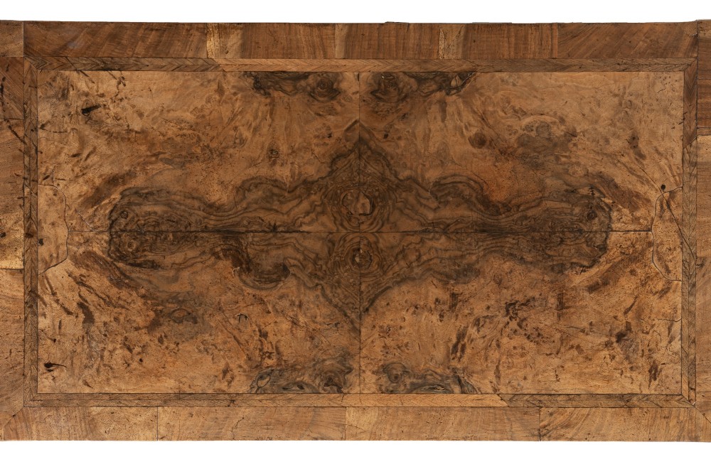 An 18th-century English burr walnut chest of drawers featuring two short over three long drawers with brass drop handles and turned bun feet. View IV