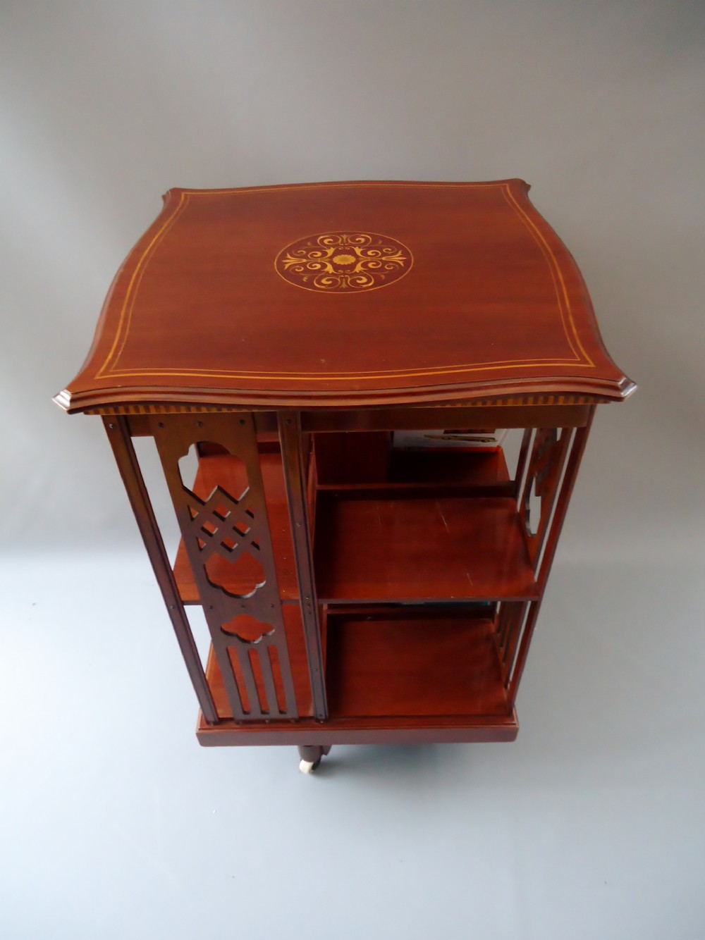 a mahogany serpentine shape revolving bookcase