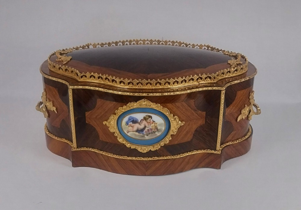 A late 19th-century French serpentine table jardiniere constructed from kingwood and tulipwood parquetry, featuring gilt bronze mounts and a central oval hand-painted porcelain medallion depicting a cherub. View V