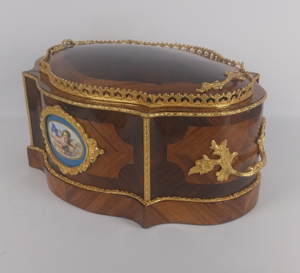 A late 19th-century French serpentine table jardiniere constructed from kingwood and tulipwood parquetry, featuring gilt bronze mounts and a central oval hand-painted porcelain medallion depicting a cherub. View VI