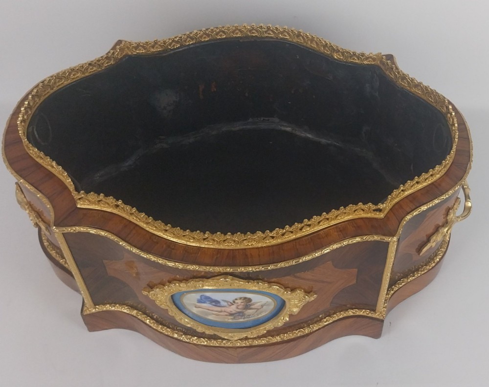 A late 19th-century French serpentine table jardiniere constructed from kingwood and tulipwood parquetry, featuring gilt bronze mounts and a central oval hand-painted porcelain medallion depicting a cherub. View IX