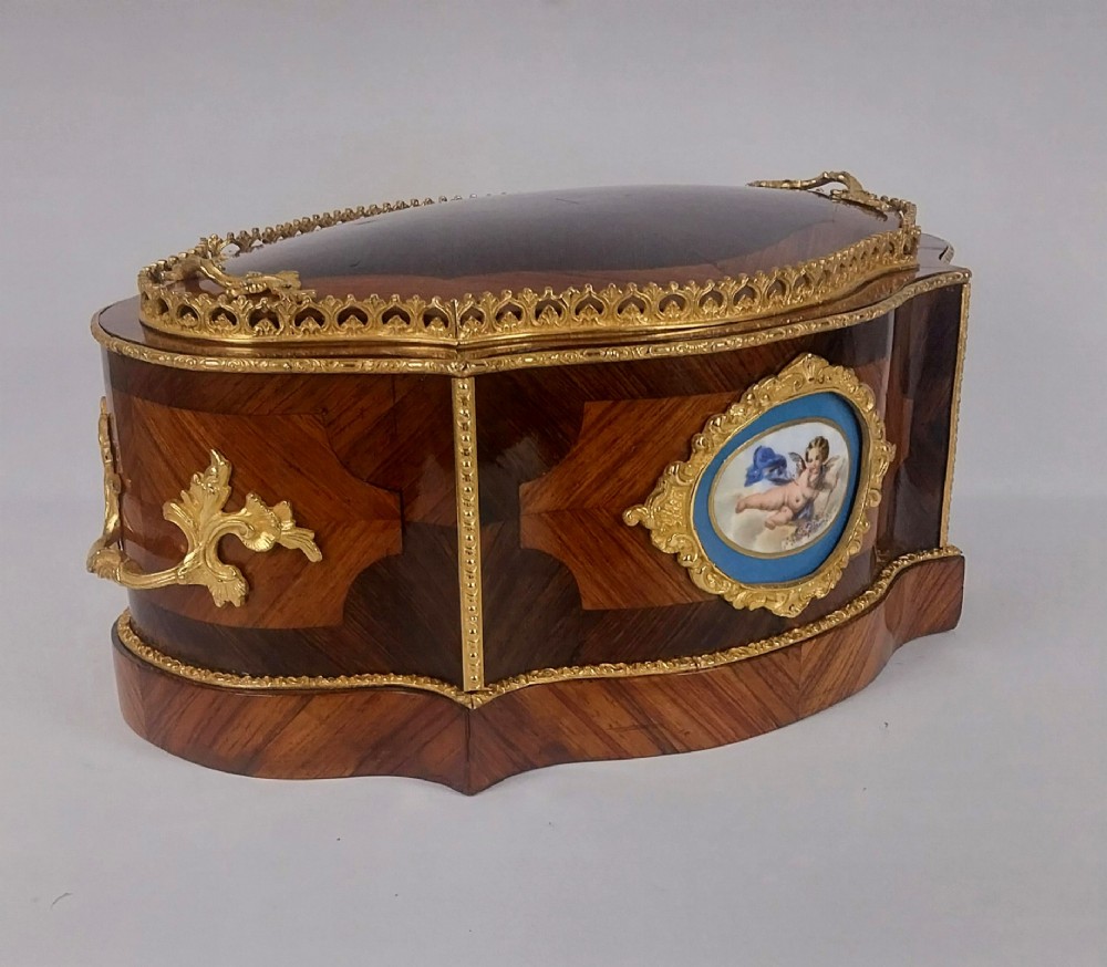 A late 19th-century French serpentine table jardiniere constructed from kingwood and tulipwood parquetry, featuring gilt bronze mounts and a central oval hand-painted porcelain medallion depicting a cherub. View X