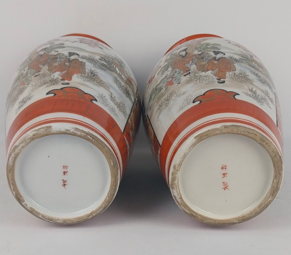 A pair of baluster-shaped Japanese Kutani porcelain vases decorated with hand-painted birds, flowers, iron-red panels, and gold accents. View X