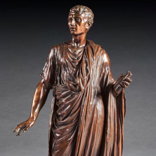 fig 1. A patinated bronze sculpture depicting a standing Roman orator clad in a draped toga holding a scroll on a square base.