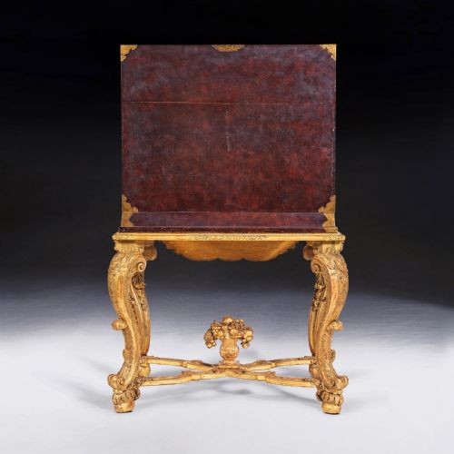 fig 7. A black Japanese lacquer cabinet with gold landscape designs and engraved brass lockplates, supported on an ornate carved French giltwood stand with cabriole legs.