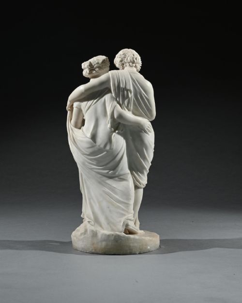 fig 3. An early 19th-century Italian carved white marble sculpture depicting the classical mythological figures of Bacchus and Ariadne standing together on an oval base.
