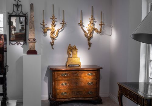 fig 1. A pair of tall Portasanta marble obelisks featuring cream and brown veining, resting on spherical red marble feet and stepped Rosso Antico bases.