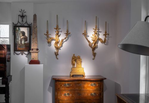 fig 5. A set of three 19th-century Neoclassical wall mirrors featuring green painted and silvered frames topped with carved urn finials and drapery swags.