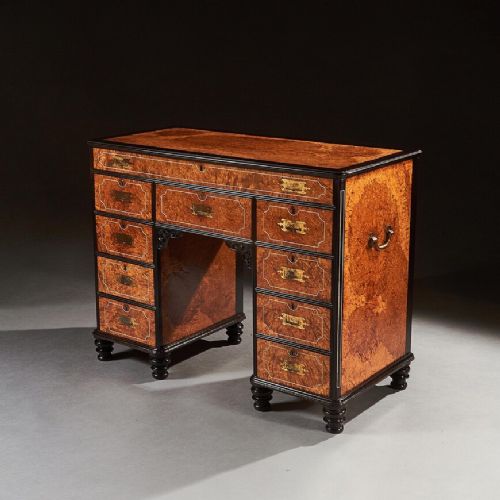 A FINE CHINESE EXPORT AMBOYNA AND EBONY CAMPAIGN KNEEHOLE DESK
