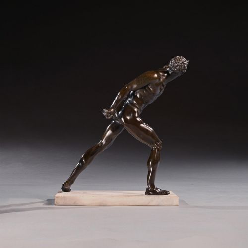 fig 4. A 19th-century patinated bronze sculpture depicting the Borghese Gladiator in a dynamic lunging pose, mounted on a light-coloured marble base.