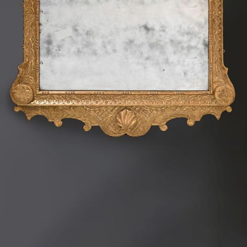 fig 2. An 18th-century George II carved gesso and giltwood wall mirror featuring a broken arch pediment with a central shell motif and foxed glass plate.