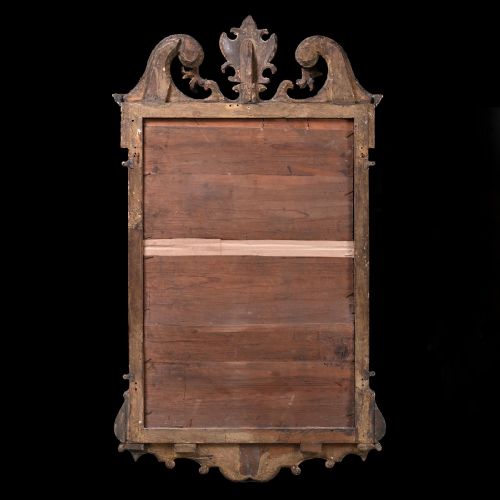 fig 3. An 18th-century George II carved gesso and giltwood wall mirror featuring a broken arch pediment with a central shell motif and foxed glass plate.