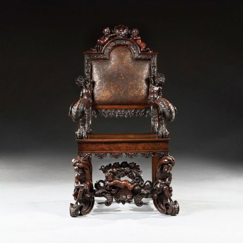 fig 1. A 19th-century Italian carved walnut armchair featuring elaborate sculptural figural supports and an embossed high backrest.