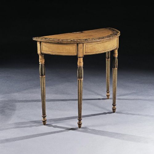 fig 3. A Georgian painted demi-lune pier table featuring a semi-circular top with polychrome painted borders and four fluted tapered legs.