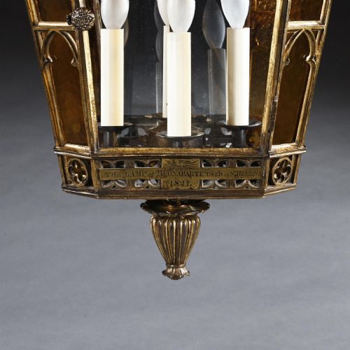 fig 1. A Regency gilt brass hall lantern featuring Gothic tracery arches, glass side panels, an upper cut-glass shade, and a hanging chain.