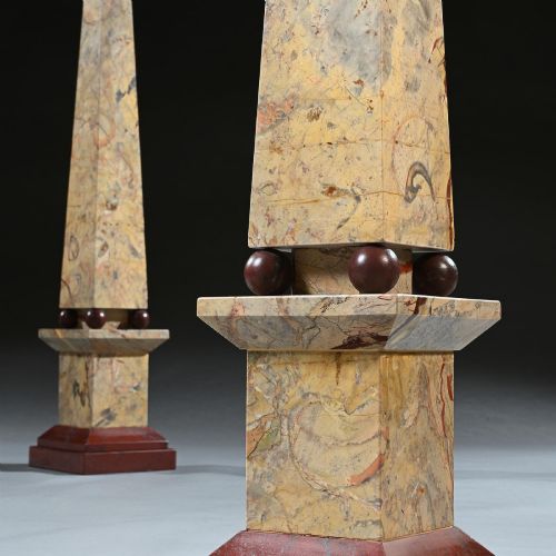 fig 4. A pair of tall, veined marble obelisks carved from Portasanta and Rosso Antico marble with polished spherical details on tiered square bases.
